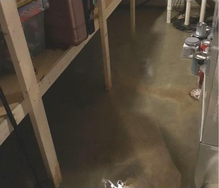 Standing water on the floor of the storage room.