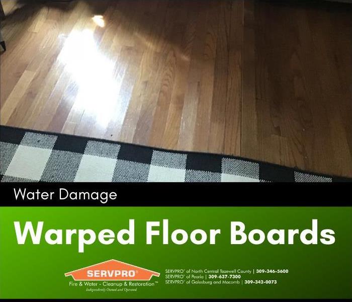 Floorboards warped from water damage in the livingroom.